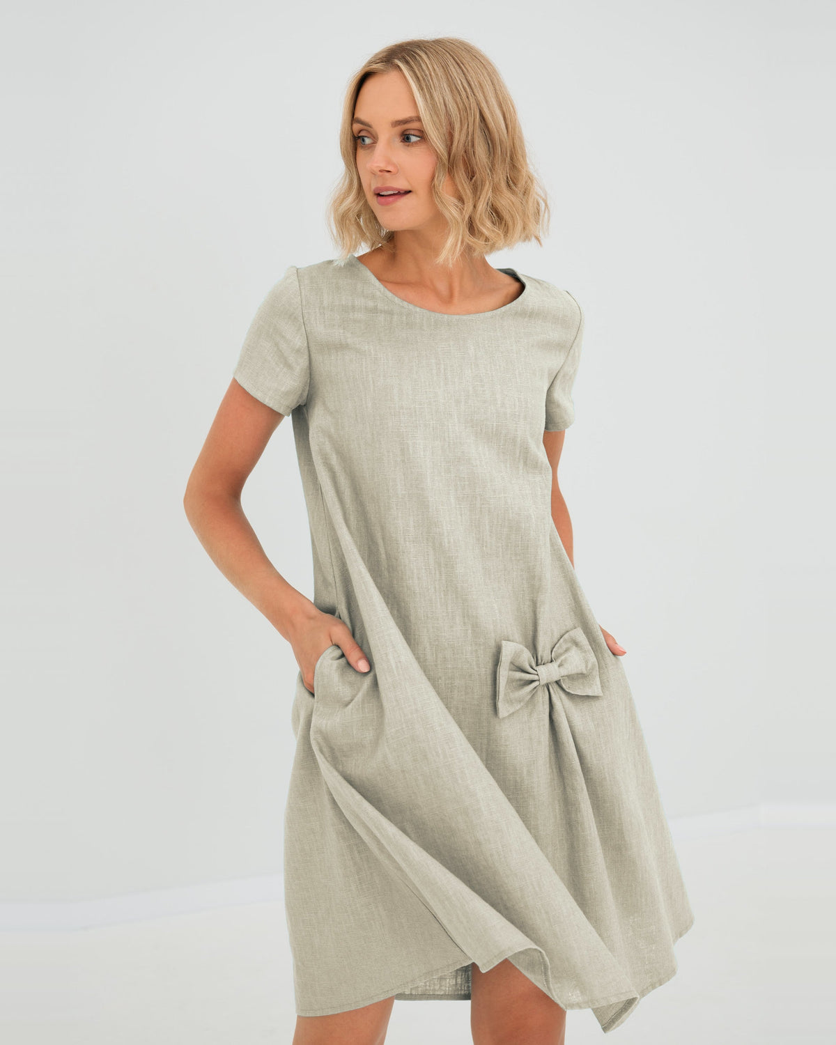 LeMuse SUMMER KISS linen dress in beige – studio front view, hand in pocket #Color_Beige