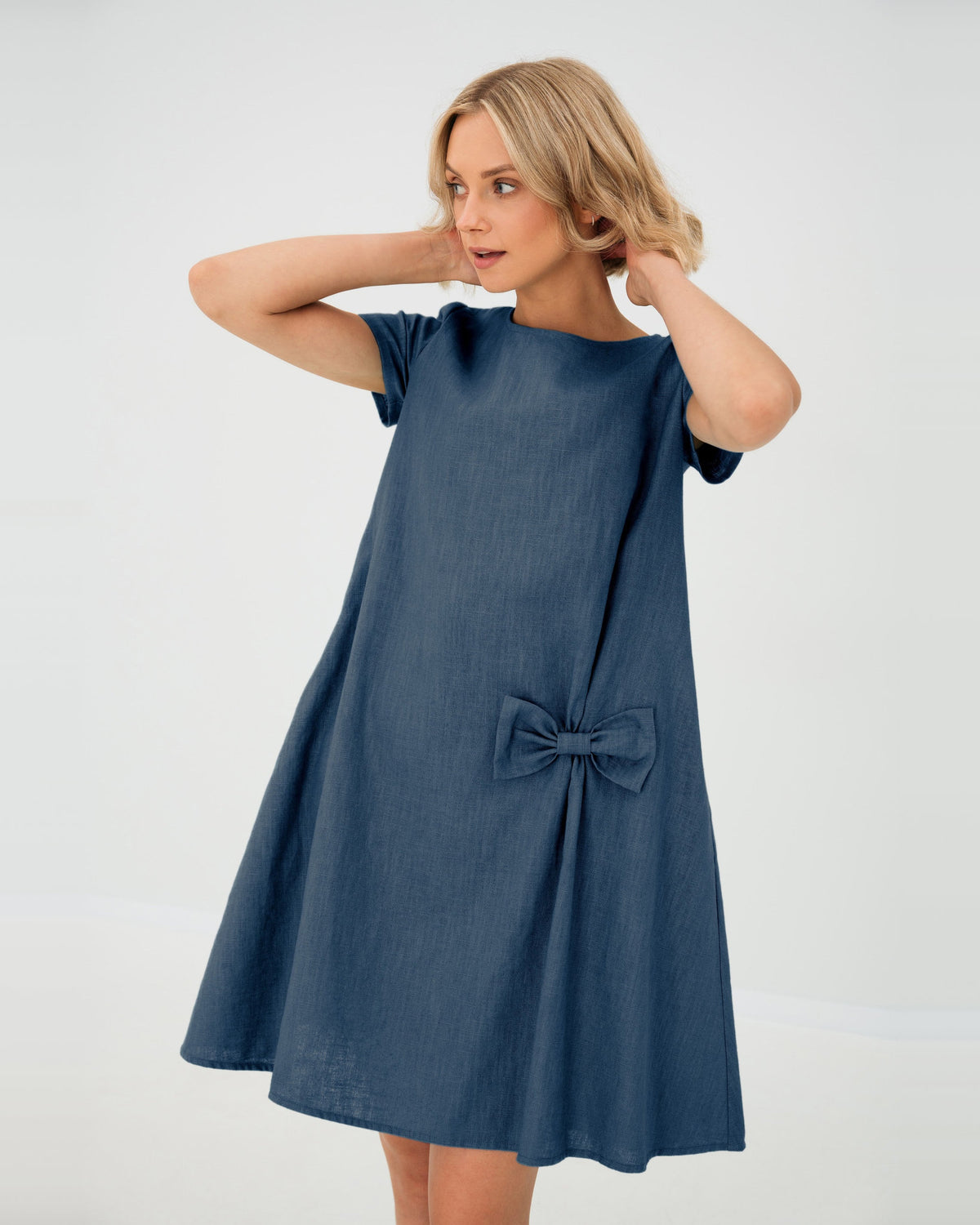 LeMuse SUMMER KISS linen dress in blue – studio front view, hands in hair #Color_Blue