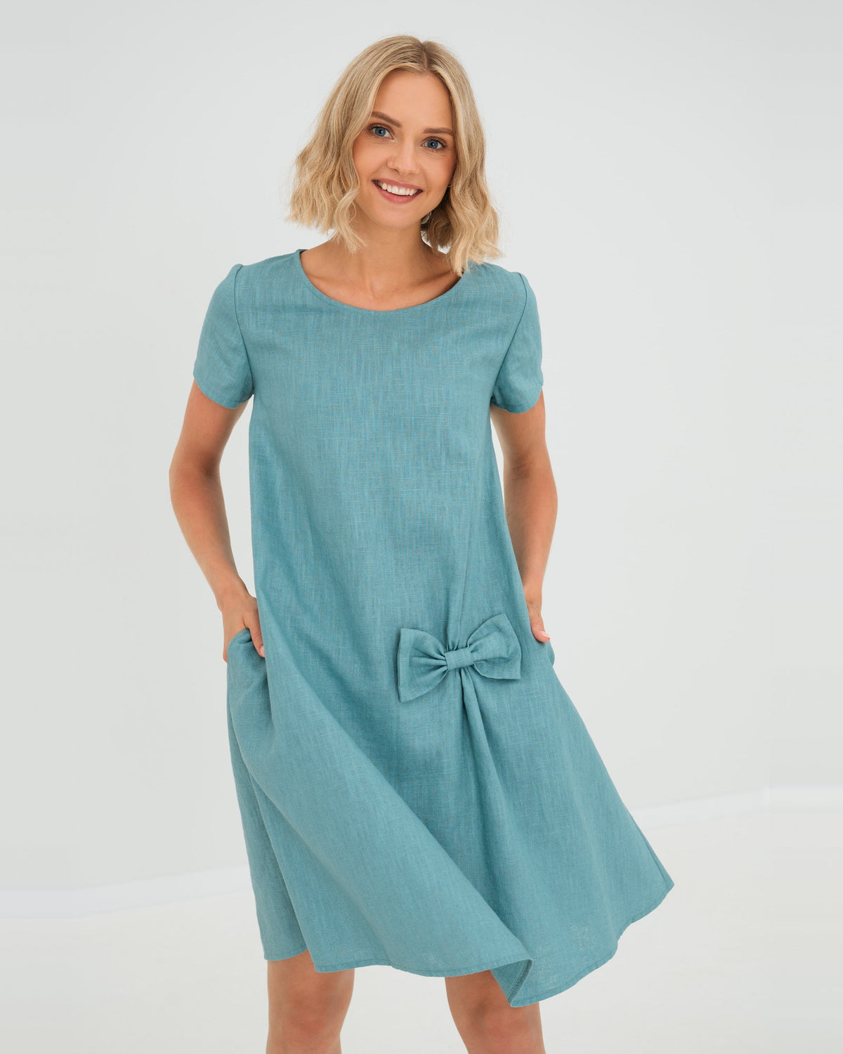 LeMuse SUMMER KISS linen dress in teal – studio front view, hands in pockets #Color_Teal