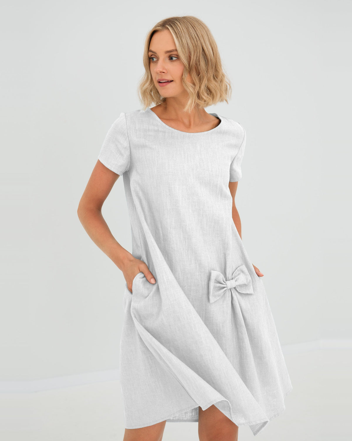 LeMuse SUMMER KISS linen dress in white – studio front view, hand in pocket #Color_White