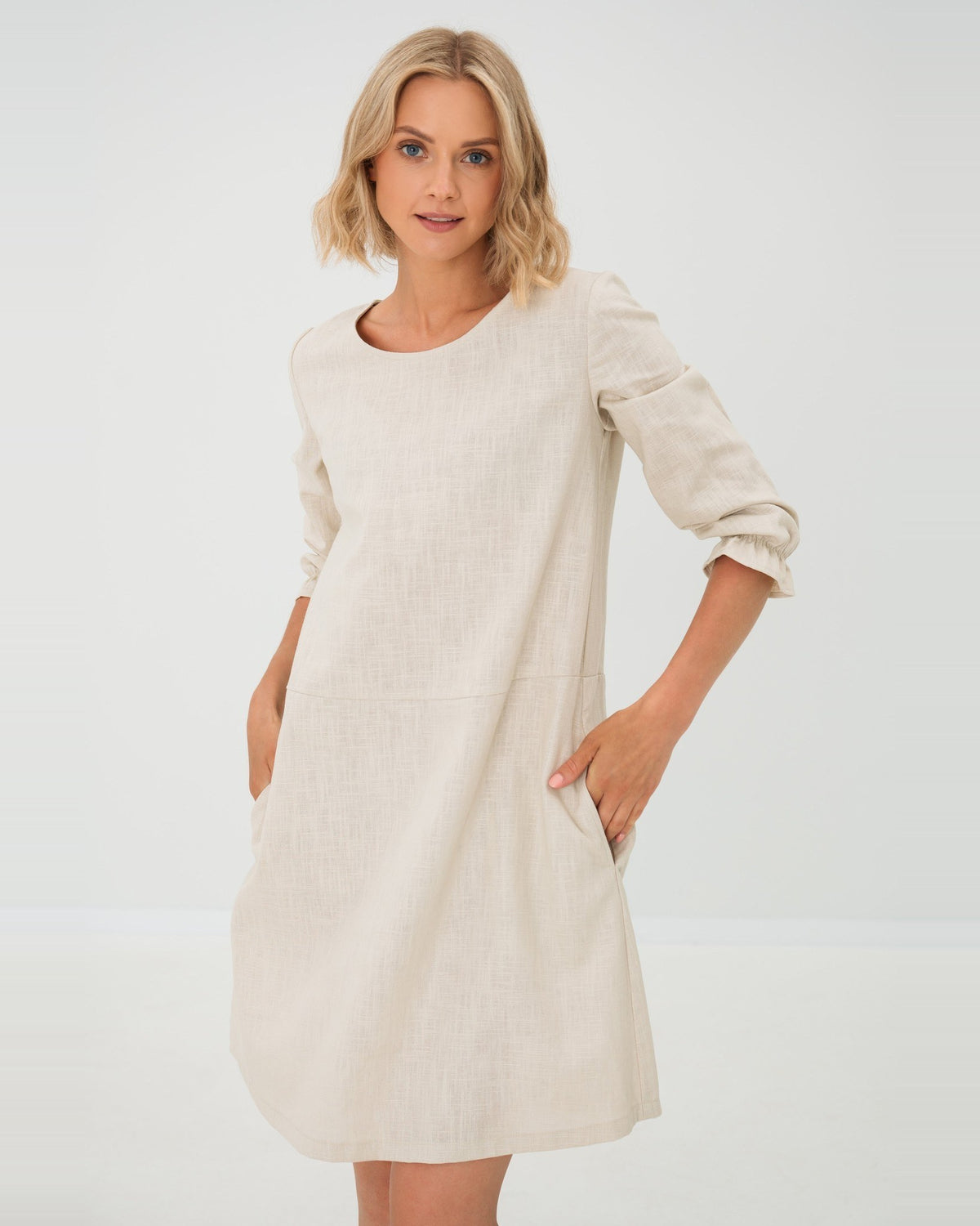 EMMA – Linen Blend Three-Quarter Sleeve Belted Dress – beige dress without belt, studio three-quarter view with drop-waist seam and side pocket #Color_Beige