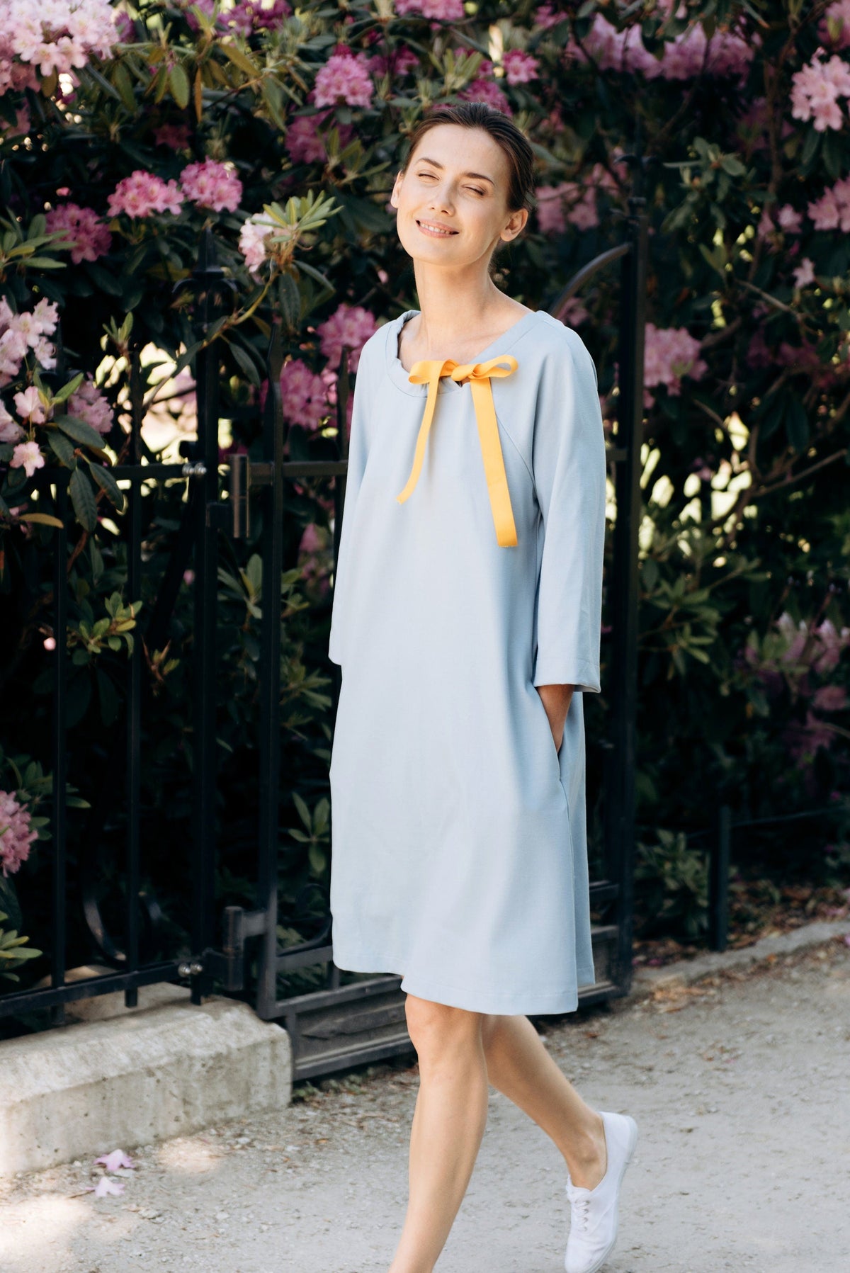 FRENCH – Italian Punto Milano Ribbon Neck A-Line Dress – sky blue dress, walking in a garden with a yellow ribbon bow #Color_Sky blue