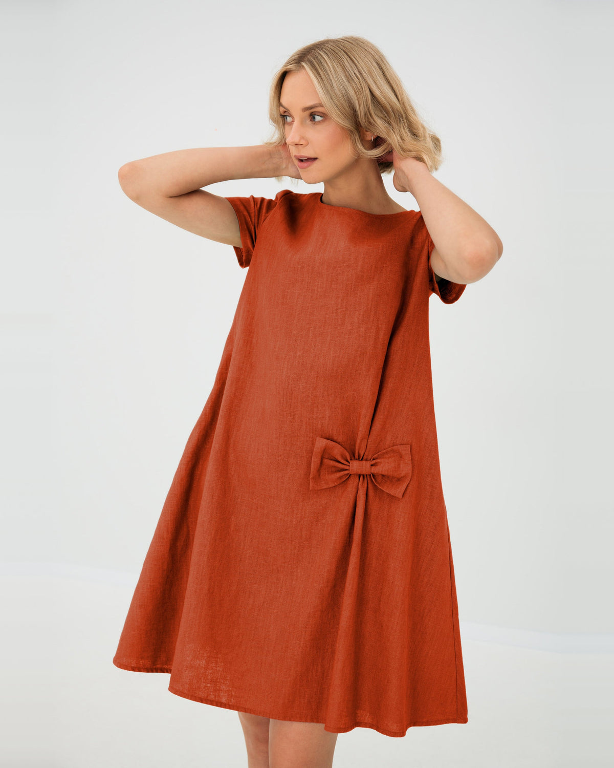 LeMuse SUMMER KISS linen dress in orange – studio front view, hands in hair #Color_Orange