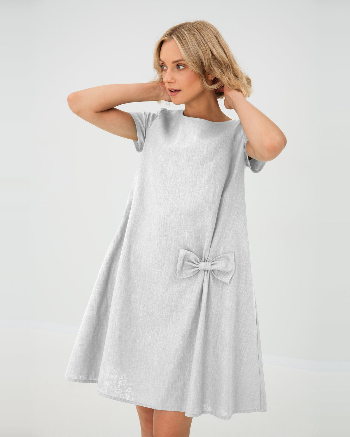 LeMuse SUMMER KISS linen dress in white – studio front view, hands in hair #Color_White