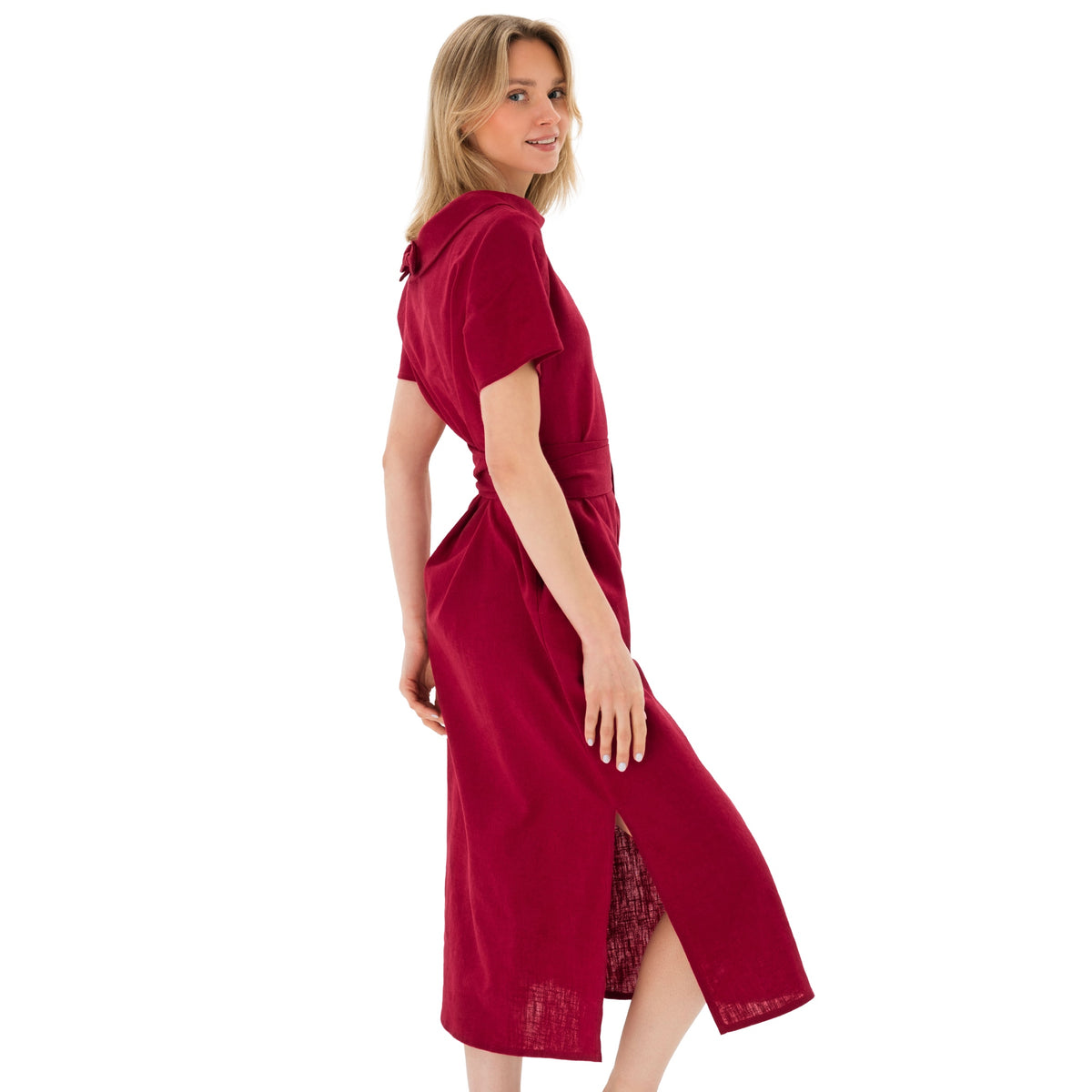 A woman modeling a short-sleeve, collared red dress with a side slit, shown from a three-quarters back angle against a plain white background.