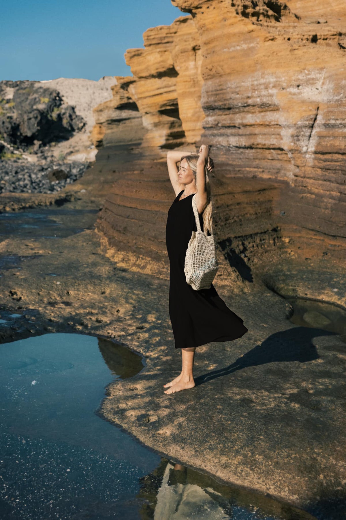 LeMuse SUNSET linen dress in black – model front full length by the cliffs #Color_Black